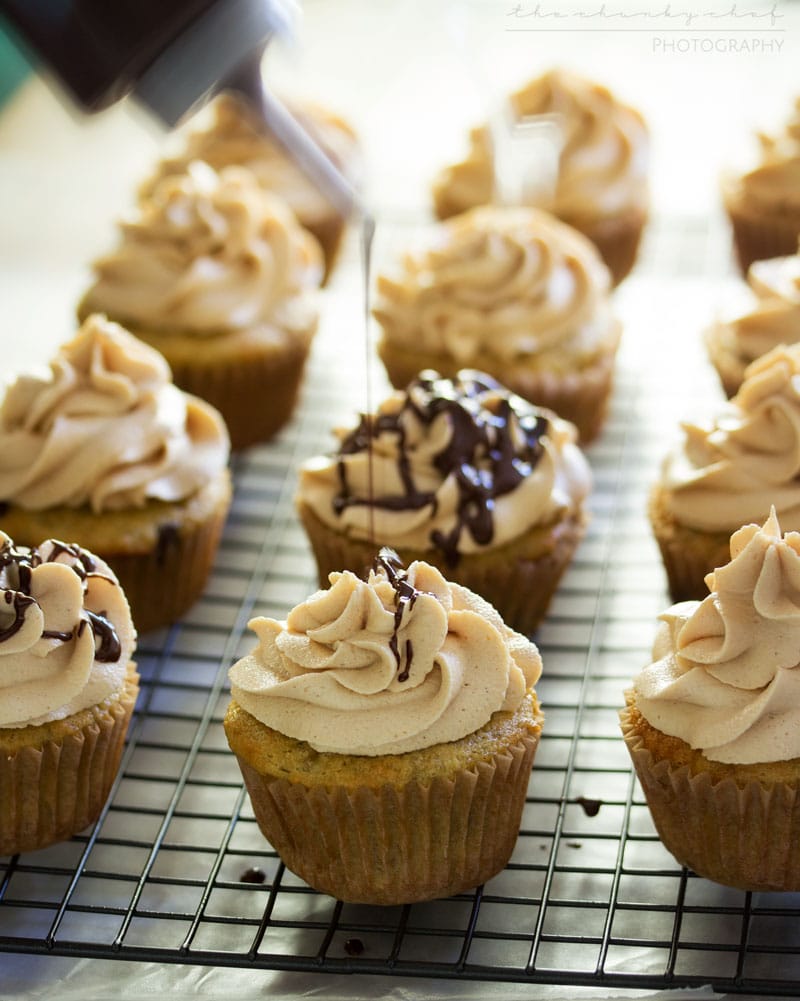 Banana Cupcakes | Unbelievably soft banana cupcakes are frosted with a creamy peanut butter cream cheese frosting that's kissed with honey, and drizzled with chocolate!