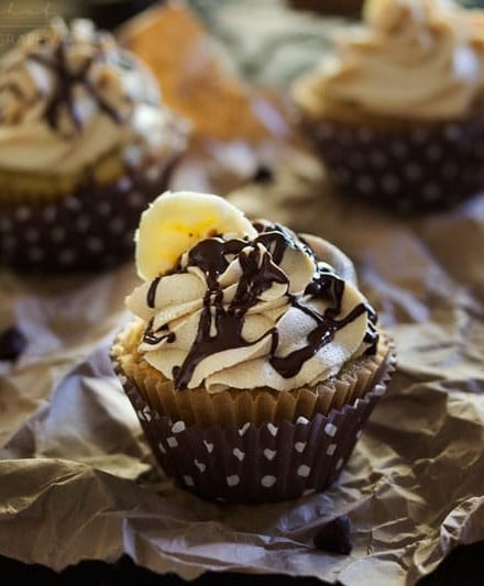 Banana Cupcakes | Unbelievably soft banana cupcakes are frosted with a creamy peanut butter cream cheese frosting that's kissed with honey, and drizzled with chocolate!