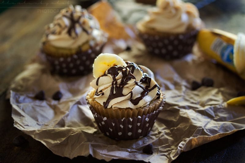 Banana Cupcakes | Unbelievably soft banana cupcakes are frosted with a creamy peanut butter cream cheese frosting that's kissed with honey, and drizzled with chocolate!