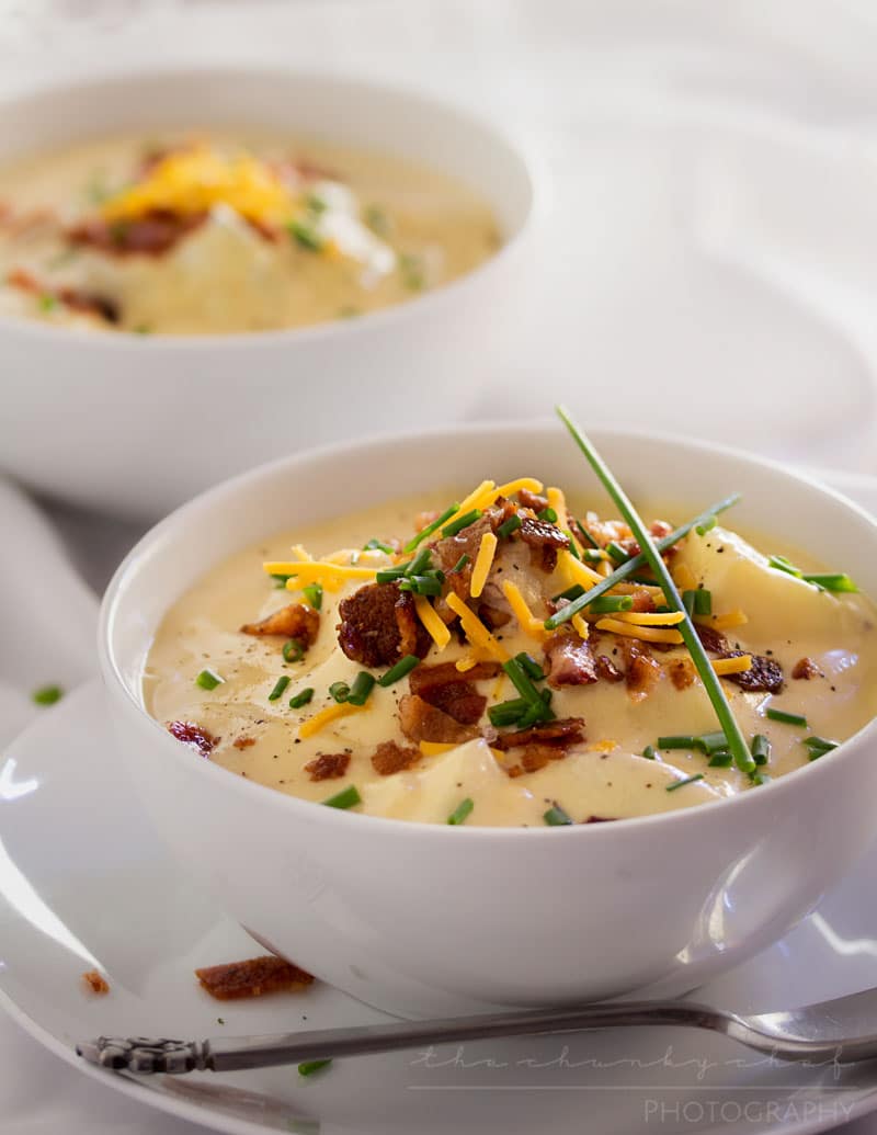 Copycat Loaded Baked Potato Soup | Creamy and thick, this potato soup is topped with savory cheese, fresh chives and crumbled bacon. It tastes just like O'Charley's loaded baked potato soup!