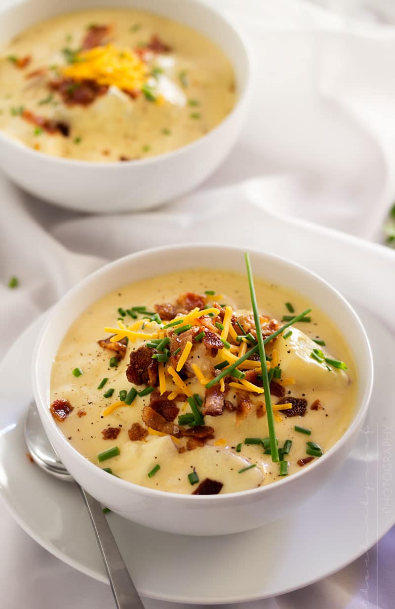 Copycat Loaded Baked Potato Soup | Creamy and thick, this potato soup is topped with savory cheese, fresh chives and crumbled bacon. It tastes just like O'Charley's loaded baked potato soup!