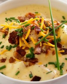 Copycat Loaded Baked Potato Soup | Creamy and thick, this potato soup is topped with savory cheese, fresh chives and crumbled bacon. It tastes just like O'Charley's loaded baked potato soup!