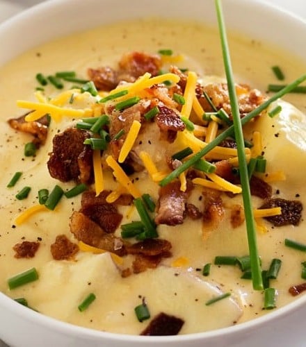 Copycat Loaded Baked Potato Soup | Creamy and thick, this potato soup is topped with savory cheese, fresh chives and crumbled bacon. It tastes just like O'Charley's loaded baked potato soup!