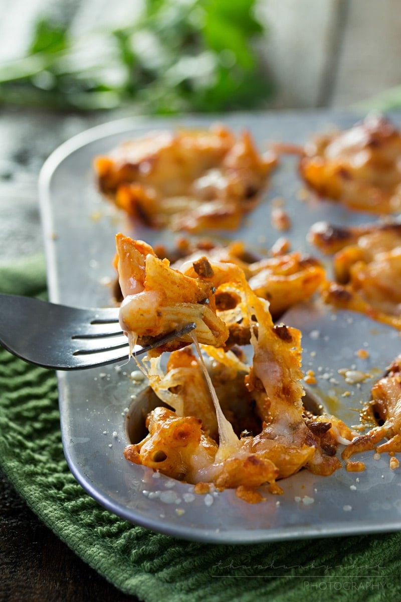 Cheesy One Bite Baked Penne Cups | Creamy, cheesy and spicy baked penne pasta is baked into mini muffin cups for the tastiest appetizer around! They're the perfect one-bite snack!