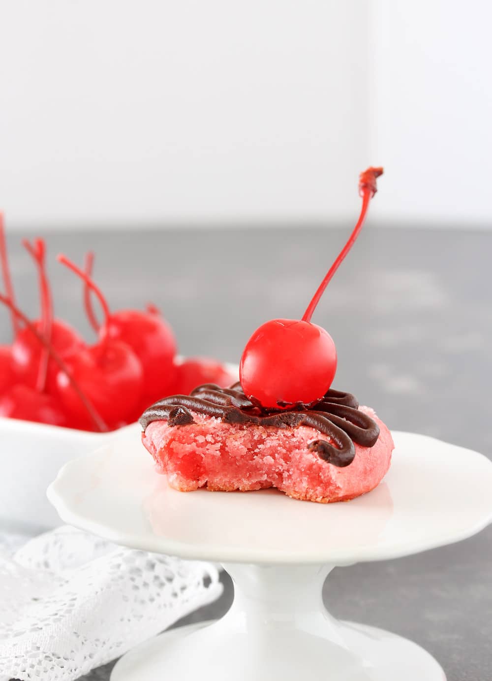 Glazed Chocolate Cherry Cookies | Soft and buttery cherry cookies, made with cherry juice and cherry pieces, are topped with a drizzle of melted chocolate, sweet glaze, and a cherry! | http://thechunkychef.com