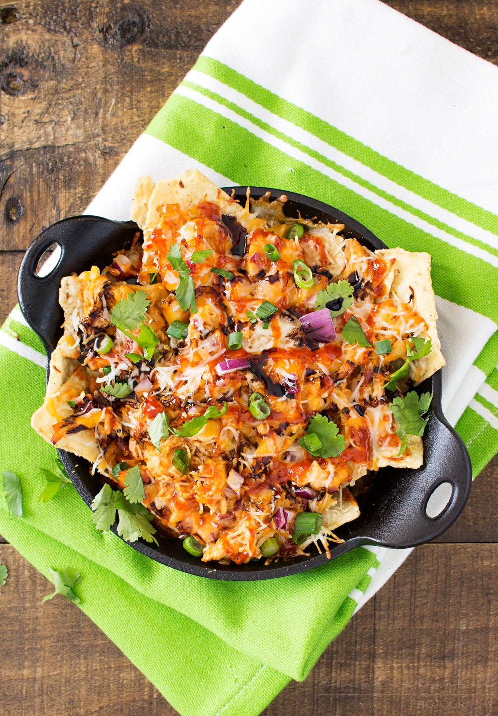 Oven Baked BBQ Chicken Pizza Nachos | Oven baked BBQ chicken pizza nachos... the awesome combination of homemade bbq sauce, juicy chicken, gooey cheese and tons of toppings! | http://thechunkychef.com