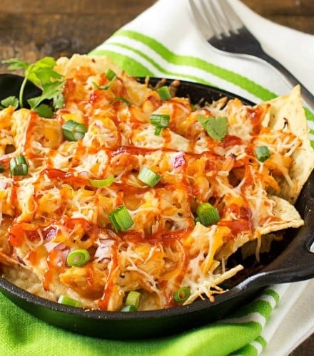 Oven Baked BBQ Chicken Pizza Nachos | Oven baked BBQ chicken pizza nachos... the awesome combination of homemade bbq sauce, juicy chicken, gooey cheese and tons of toppings! | http://thechunkychef.com