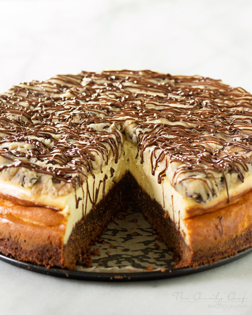 Brownie-Bottom-Cookie-Dough-Cheesecake | This impressive, yet super easy, brownie bottom cookie dough cheesecake looks as fancy as any dessert you've had from a restaurant! The ULTIMATE cheesecake for the ULTIMATE dessert lover! | http://thechunkychef.com