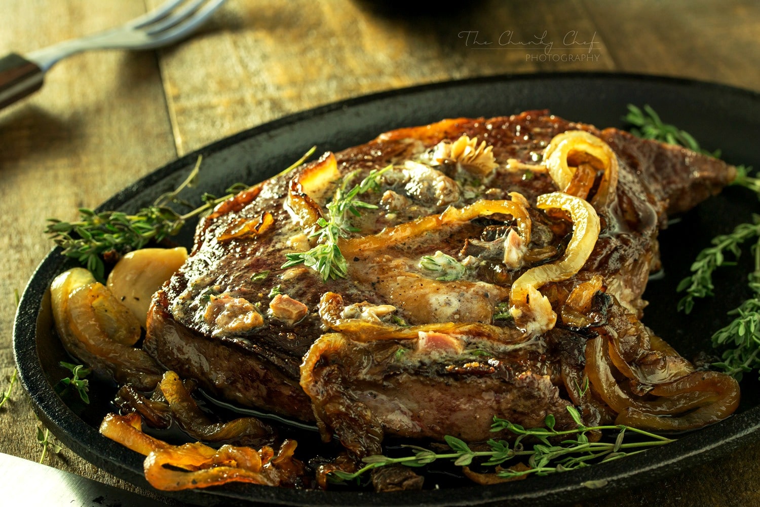 Pan Seared Steak |Tender steak is pan seared and oven roasted to juicy perfection, then topped with a porcini mushroom and herb compound butter and caramelized onions! |http://thechunkychef.com