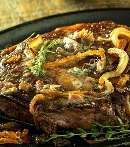 Pan Seared Steak |Tender steak is pan seared and oven roasted to juicy perfection, then topped with a porcini mushroom and herb compound butter and caramelized onions! |http://thechunkychef.com