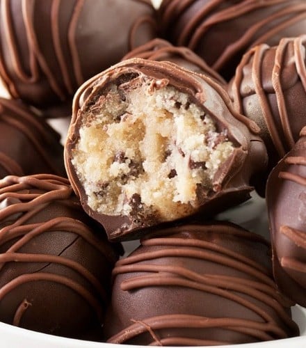 Triple Chocolate Cookie Dough Truffles | These cookie dough truffles are made from an egg-less cookie dough with semi sweet chocolate chips, then coated in two different kinds of chocolate! | http://thechunkychef.com