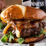 Whiskey-Glazed-Blue-Cheese-Burgers | These blue cheese burgers are brushed with a homemade whiskey glazed, topped with Irish cheese, and smothered in Guinness caramelized onions! | http://thechunkychef.com