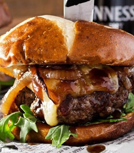 Whiskey-Glazed-Blue-Cheese-Burgers | These blue cheese burgers are brushed with a homemade whiskey glazed, topped with Irish cheese, and smothered in Guinness caramelized onions! | http://thechunkychef.com