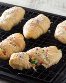 Funfetti-Cheesecake-Stuffed-Crescent-Rolls - Buttery crescent rolls are filled with an easy funfetti cheesecake spread, baked until golden, and drizzled with a vanilla glaze!! Perfect for kids! | http://thechunkychef.com