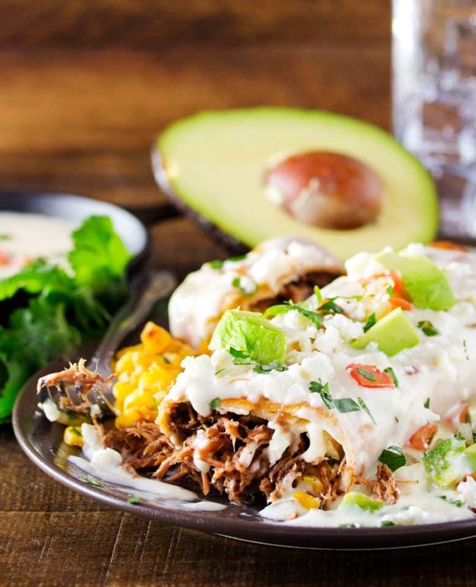 Smothered beef chimichangas on plate