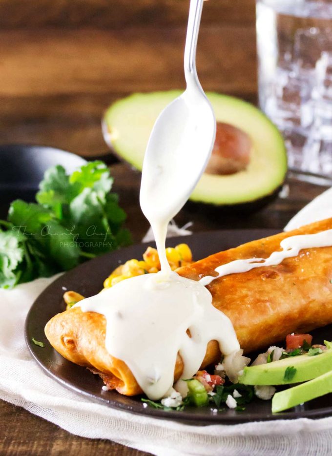 White queso drizzled on beef chimichangas