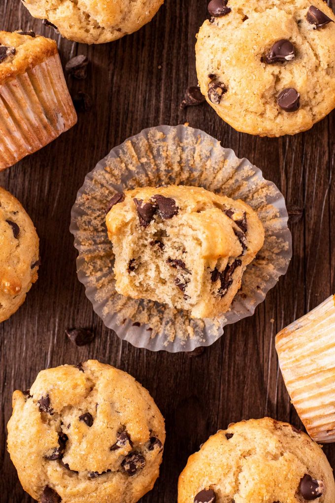 unwrapped chocolate chip muffin with bite taken out of it