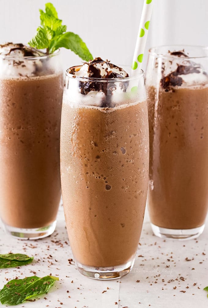 Iced coffee cocktail or frappe with ice cubes and cream in