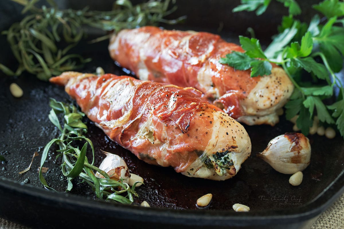 Florentine Stuffed Chicken | This Florentine stuffed chicken is filled with a deliciously cheesy spinach mixture, and toasted pine nuts, then wrapped in prosciutto and baked! | http://thechunkychef.com