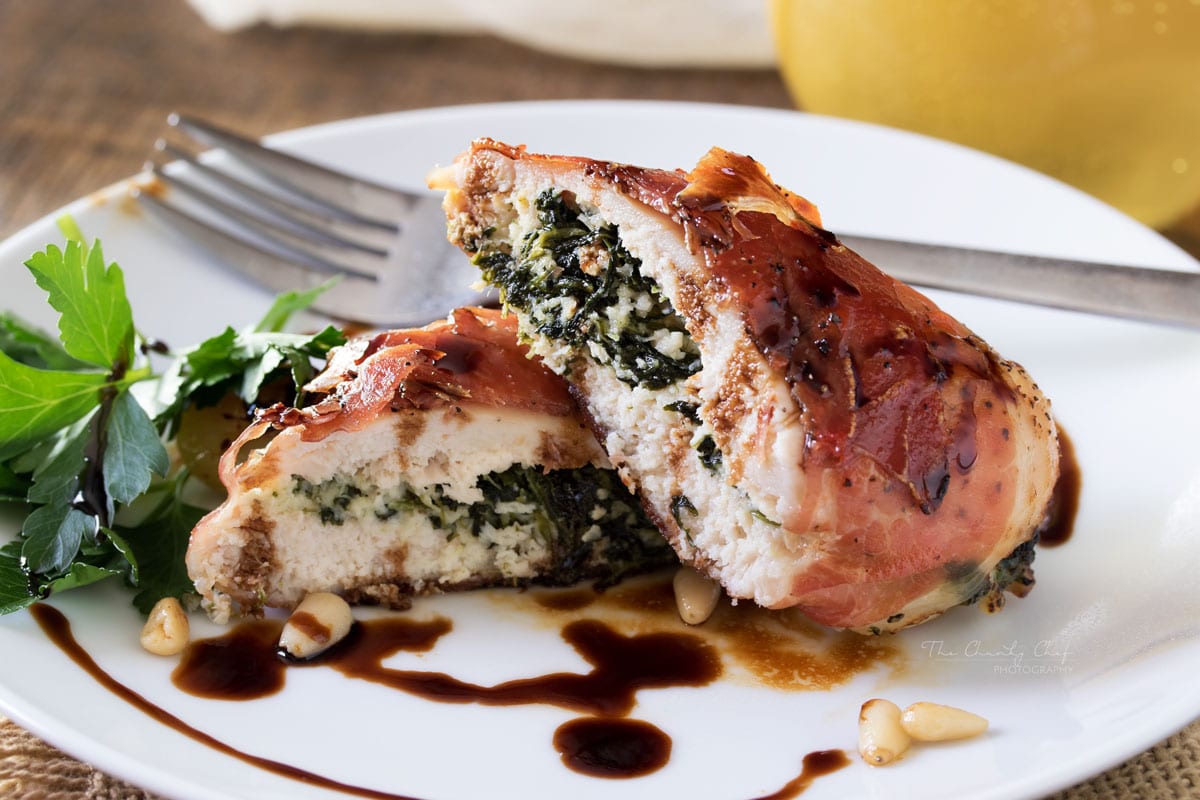 Florentine Stuffed Chicken | This Florentine stuffed chicken is filled with a deliciously cheesy spinach mixture, and toasted pine nuts, then wrapped in prosciutto and baked! | http://thechunkychef.com