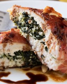Florentine Stuffed Chicken | This Florentine stuffed chicken is filled with a deliciously cheesy spinach mixture, and toasted pine nuts, then wrapped in prosciutto and baked! | http://thechunkychef.com
