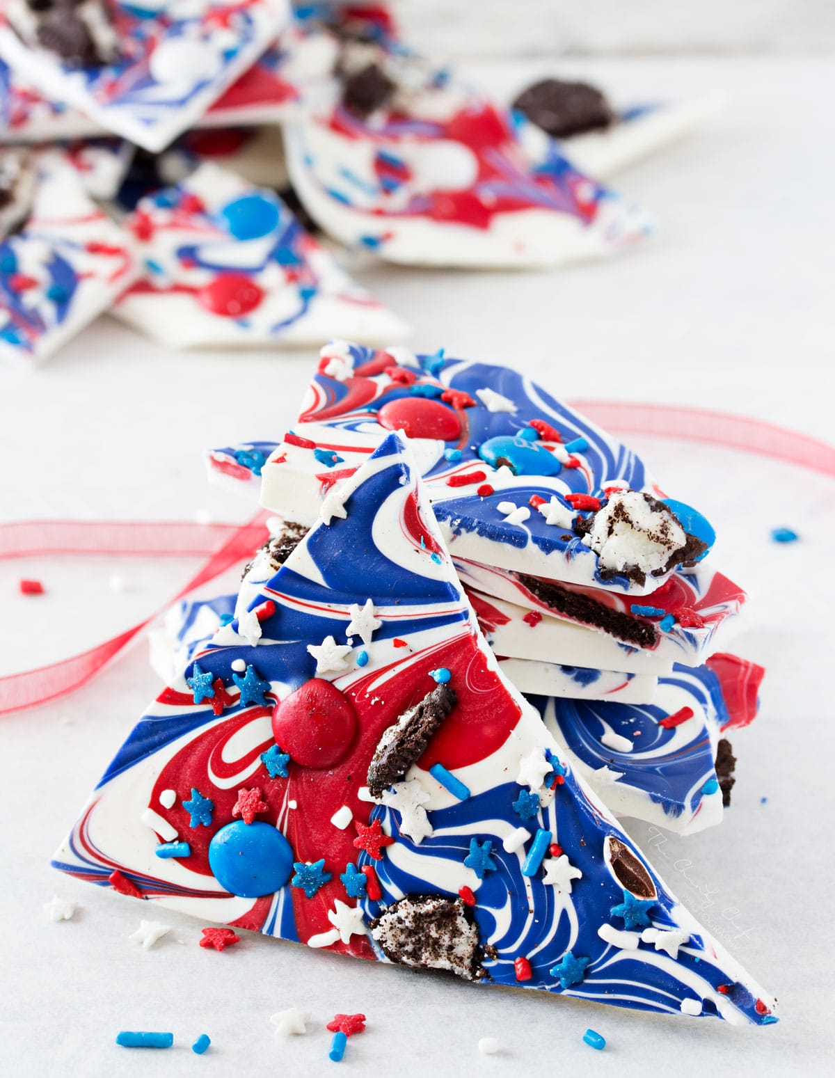 Festive Red White and Blue Bark | This simple and fun no-bake bark recipe is perfect for Memorial Day or Independence Day! So simple, even your kids can make it! | http://thechunkychef.com