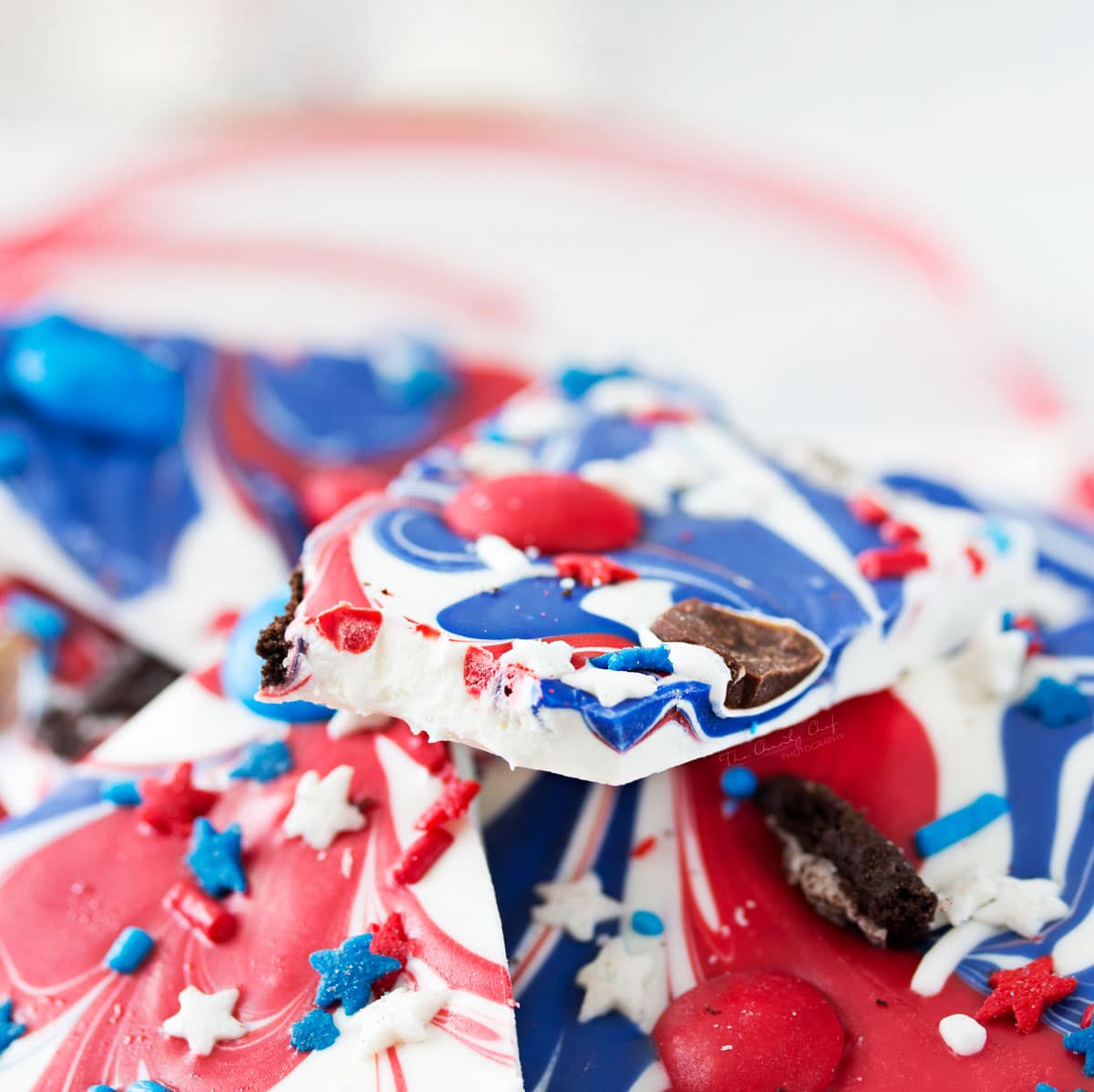 Festive Red White and Blue Bark | This simple and fun no-bake bark recipe is perfect for Memorial Day or Independence Day! So simple, even your kids can make it! | http://thechunkychef.com