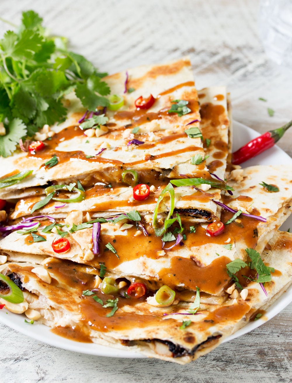 Thai Peanut Chicken Quesadillas | Thai chicken gets a fusion twist in these Thai peanut chicken quesadillas! Loaded with flavor and fun to make, try them tonight! | http://thechunkychef.com