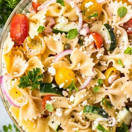 Always a crowd-pleaser, this pasta salad has won first place in several potluck contests.  Summer vegetables, tender pasta, salty cheese, and a mouthwatering zesty dressing! #pastasalad #potluck #bbq #italian #greek #mediterranean #pasta, #salad #makeaheadrecipe #easyrecipe