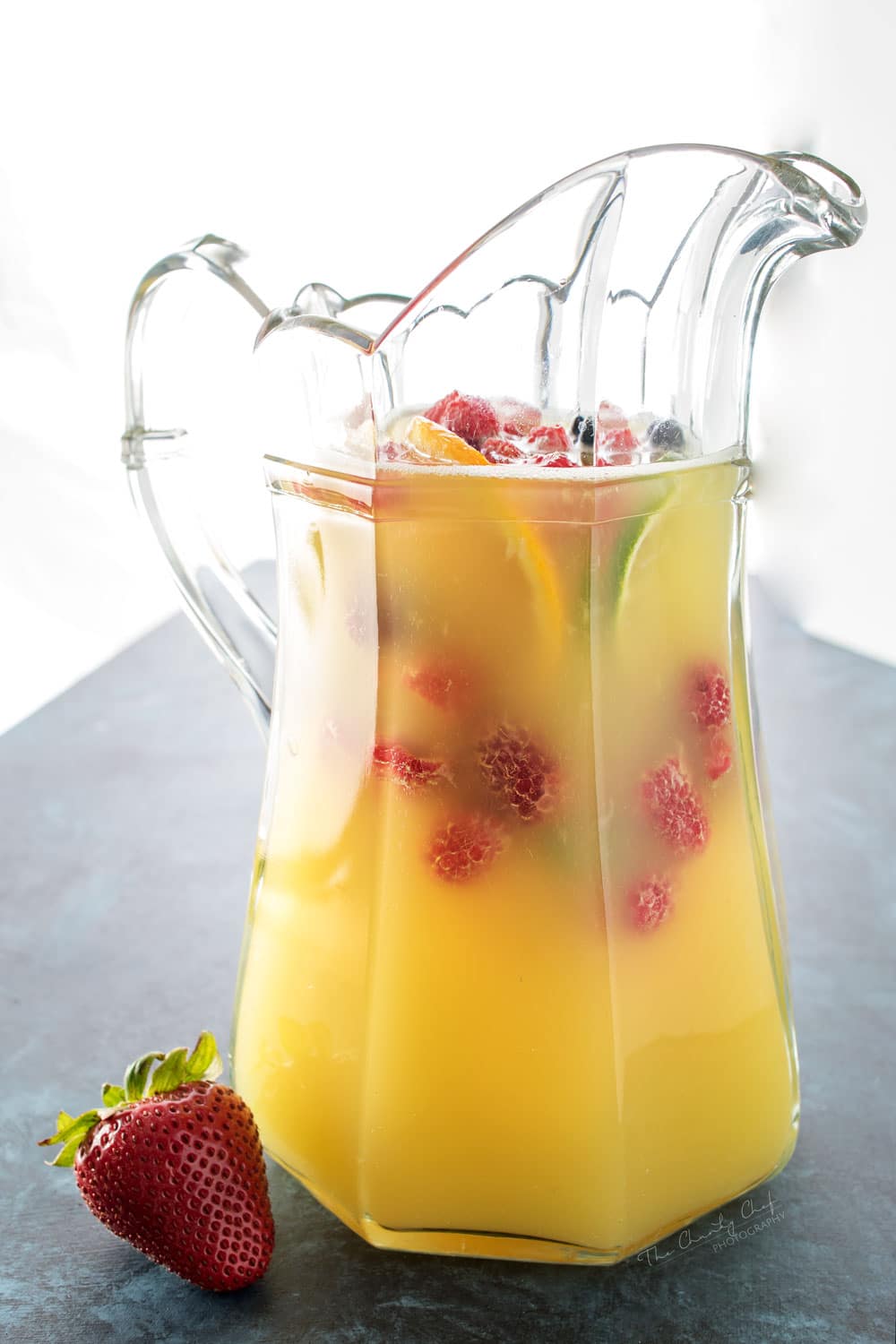 Summer Pineapple Punch | This sweet and easy to make pineapple punch will be the hit of any party! Just 4 simple ingredients plus fresh fruit and pretty garnishes! | http://thechunkychef.com