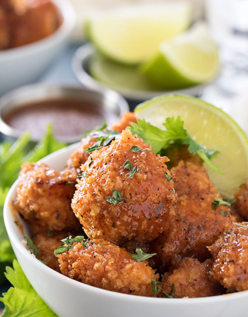 Baked Caribbean Jerk Chicken Bites | These ultra crispy chicken bites are lightened up by baking instead of frying in oil, then tossed in a mouthwatering copycat Caribbean Jerk sauce! | http://thechunkychef.com