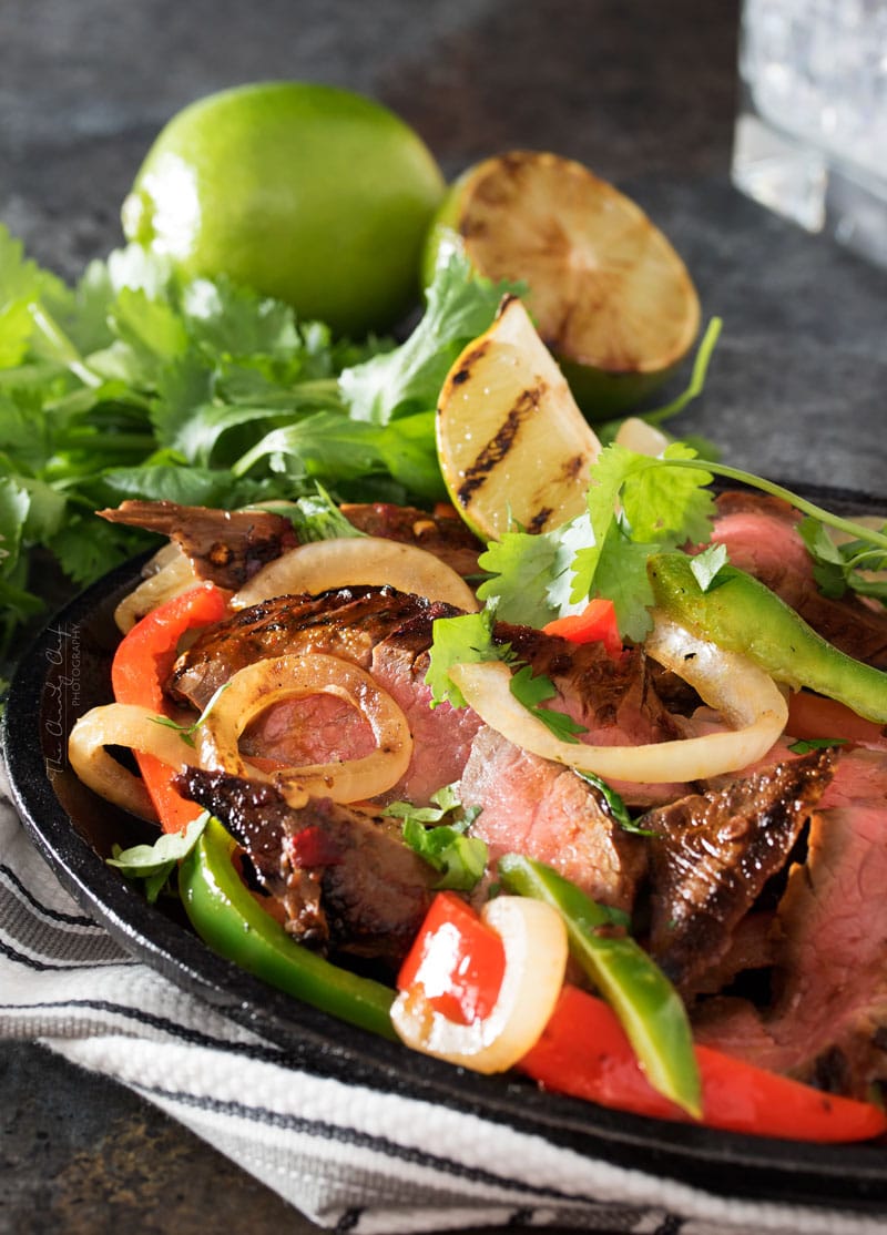 Carne Asada Steak Fajitas | Tender marinated carne asada steak, grilled until charred on the outside, and tossed with grilled peppers and onions for the most delicious steak fajitas! | http://thechunkychef.com