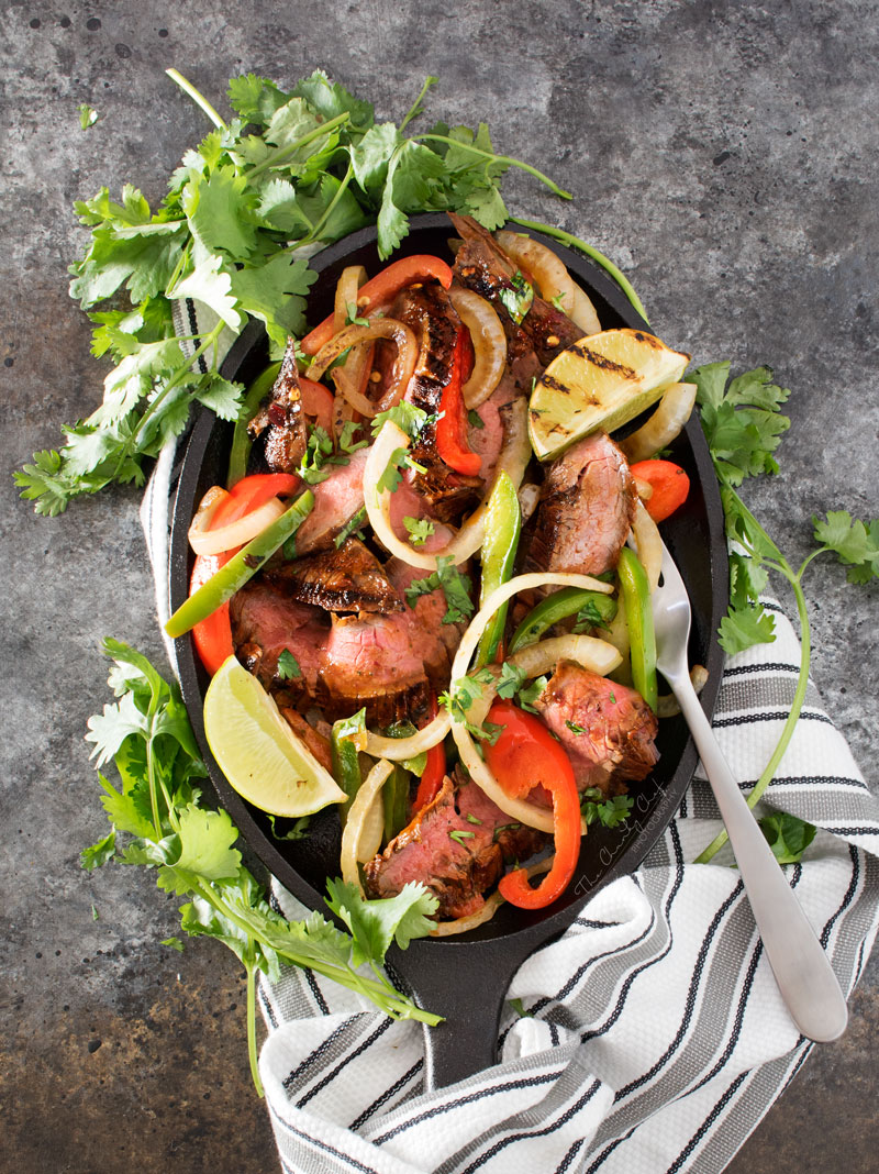 Carne Asada Steak Fajitas | Tender marinated carne asada steak, grilled until charred on the outside, and tossed with grilled peppers and onions for the most delicious steak fajitas! | http://thechunkychef.com