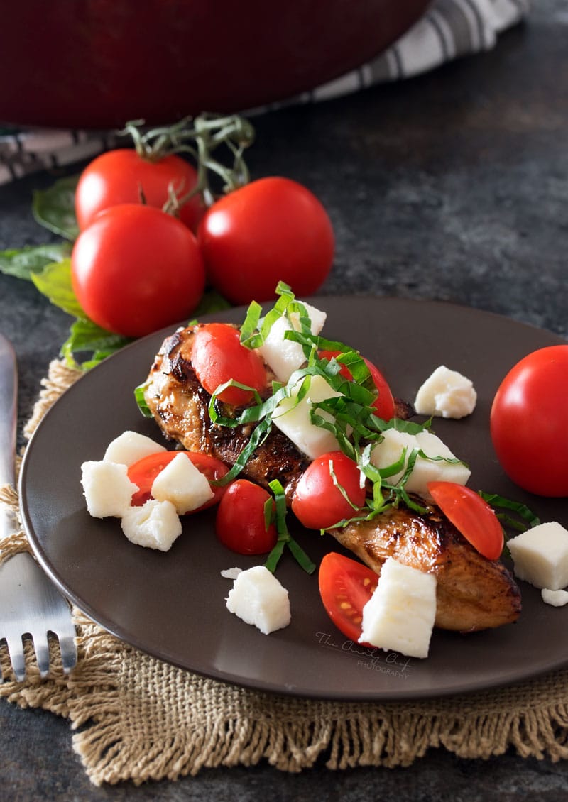 Garlic Balsamic Caprese Chicken | Juicy caprese chicken, marinated in a garlic balsamic marinade, is baked to perfection with burst cherry tomatoes, melted mozzarella cheese, fresh basil! | http://thechunkychef.com