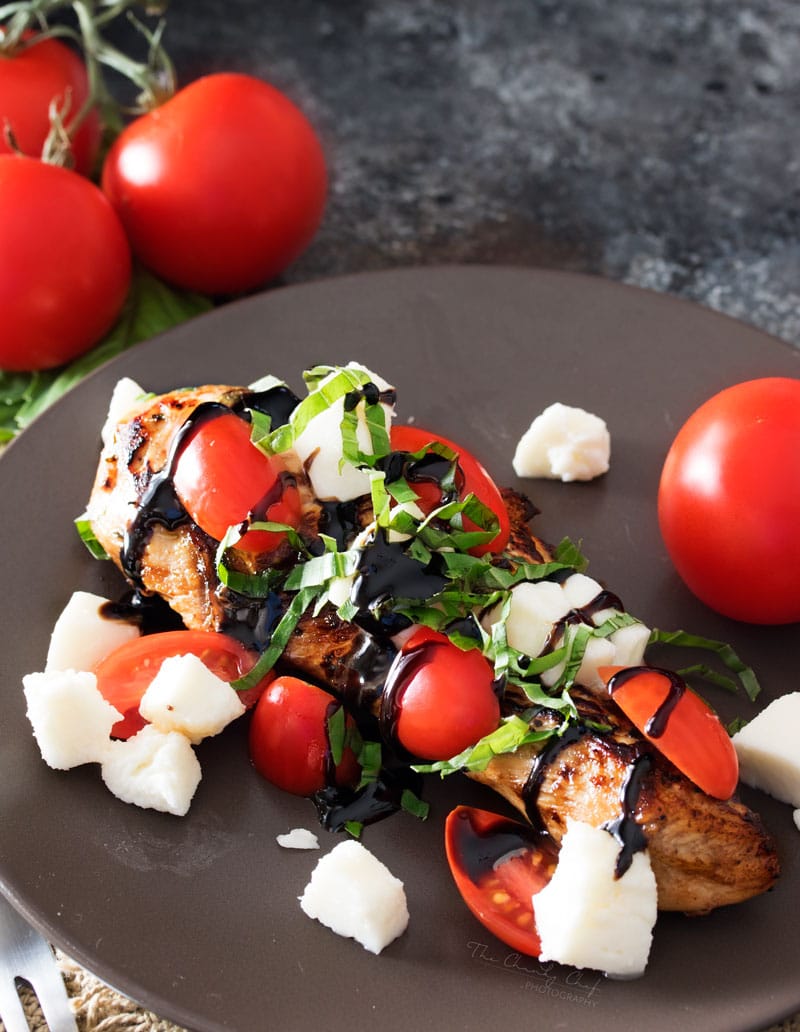 Garlic Balsamic Caprese Chicken | Juicy caprese chicken, marinated in a garlic balsamic marinade, is baked to perfection with burst cherry tomatoes, melted mozzarella cheese, fresh basil! | http://thechunkychef.com