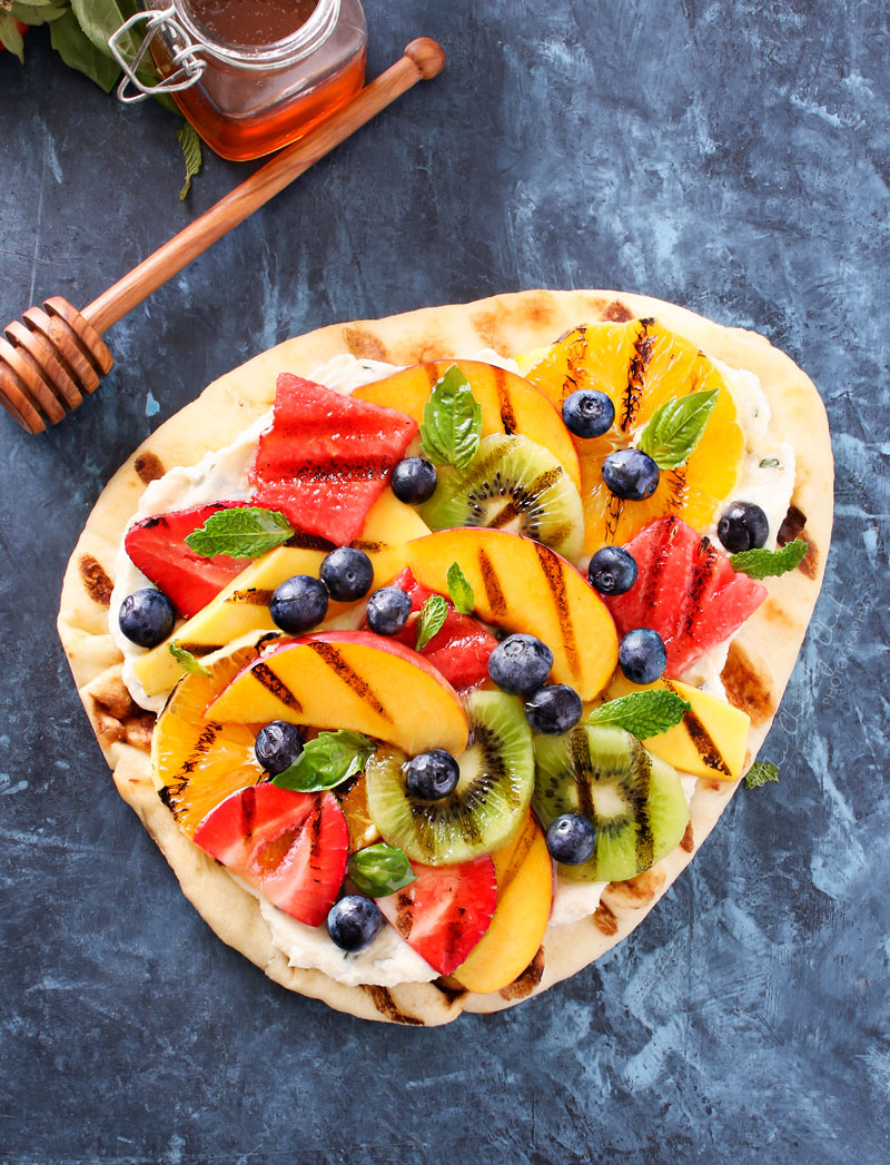 Grilled Fruit Pizza | Flatbread slathered with a glorious honey herb whipped ricotta, topped with delicious grilled fruit, drizzled with honey and sprinkled with fresh herbs! | http://thechunkychef.com