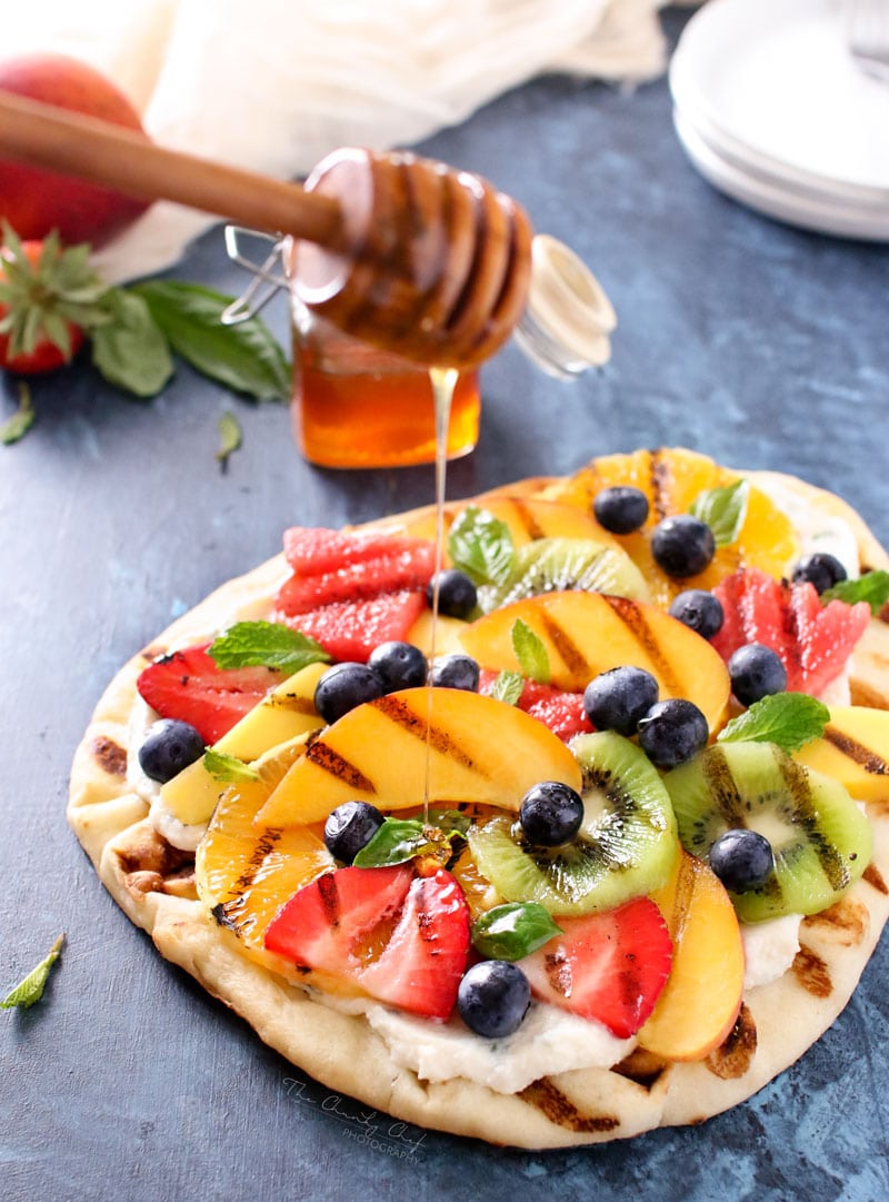 Grilled Fruit Pizza | Flatbread slathered with a glorious honey herb whipped ricotta, topped with delicious grilled fruit, drizzled with honey and sprinkled with fresh herbs! | http://thechunkychef.com