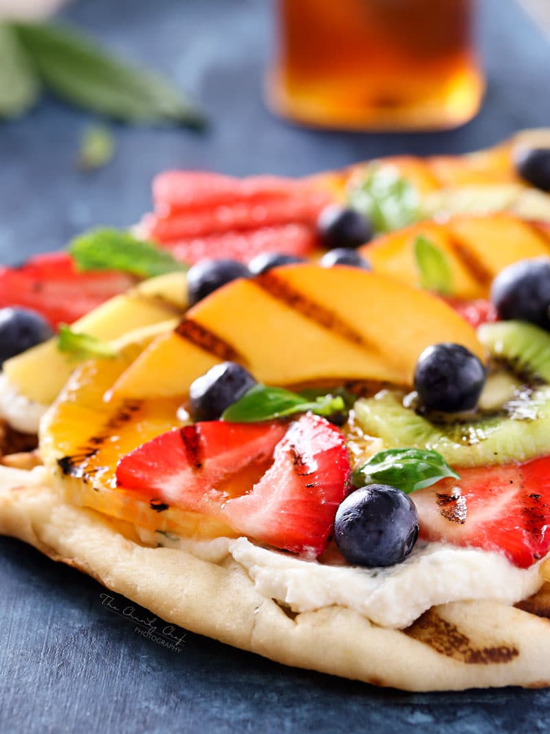 Grilled Fruit Pizza | Flatbread slathered with a glorious honey herb whipped ricotta, topped with delicious grilled fruit, drizzled with honey and sprinkled with fresh herbs! | http://thechunkychef.com