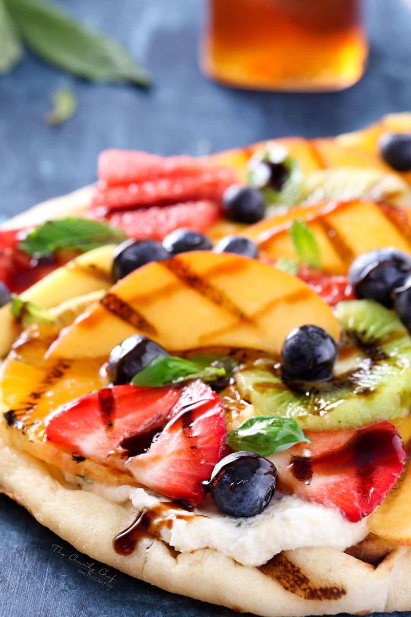 Grilled Fruit Pizza | Flatbread slathered with a glorious honey herb whipped ricotta, topped with delicious grilled fruit, drizzled with honey and sprinkled with fresh herbs! | http://thechunkychef.com