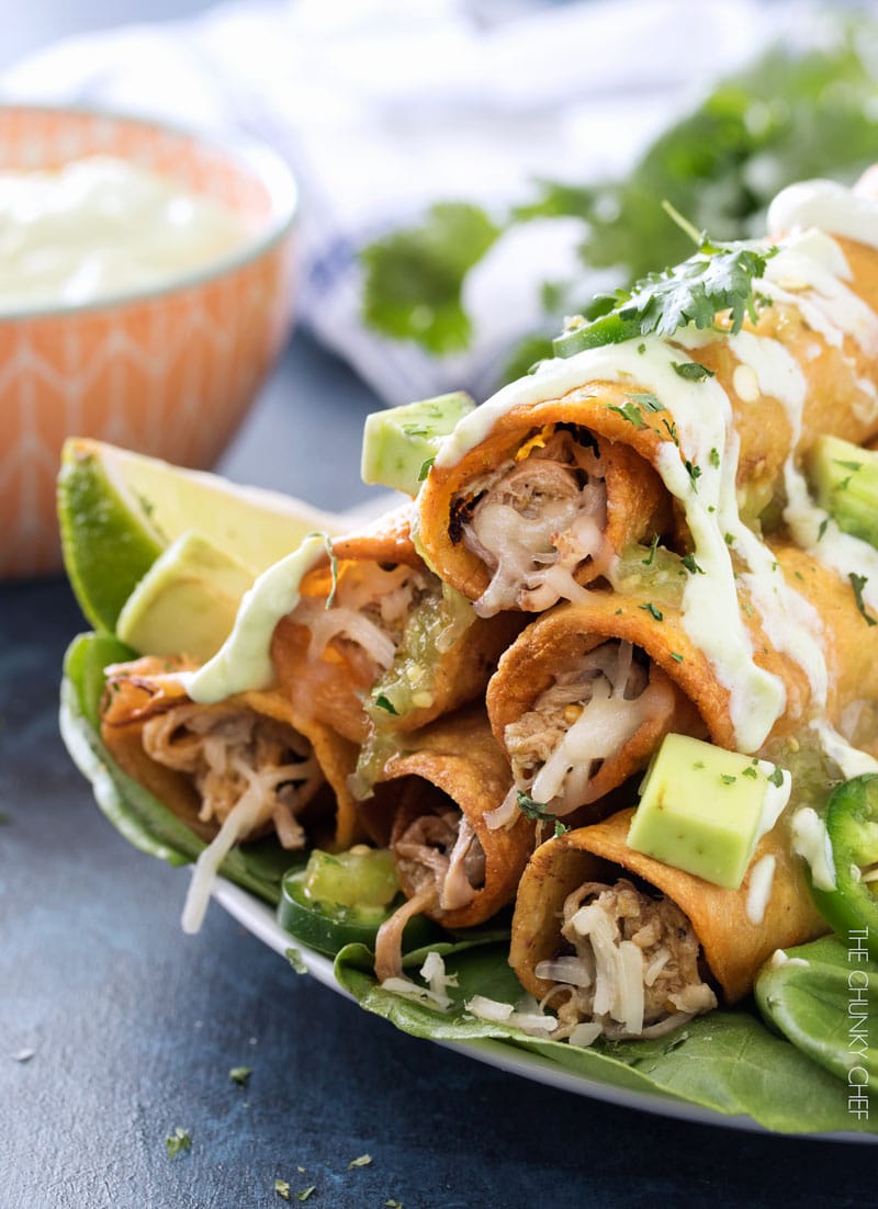 Slow Cooker Salsa Verde Pork Taquitos | The pork for these taquitos is simmered in a homemade salsa verde, shredded, piled high with cheese, wrapped up in tender corn tortillas and fried! | http://thechunkychef.com