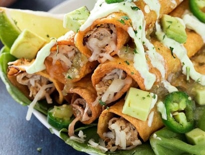 Slow Cooker Salsa Verde Pork Taquitos | The pork for these taquitos is simmered in a homemade salsa verde, shredded, piled high with cheese, wrapped up in tender corn tortillas and fried! | http://thechunkychef.com