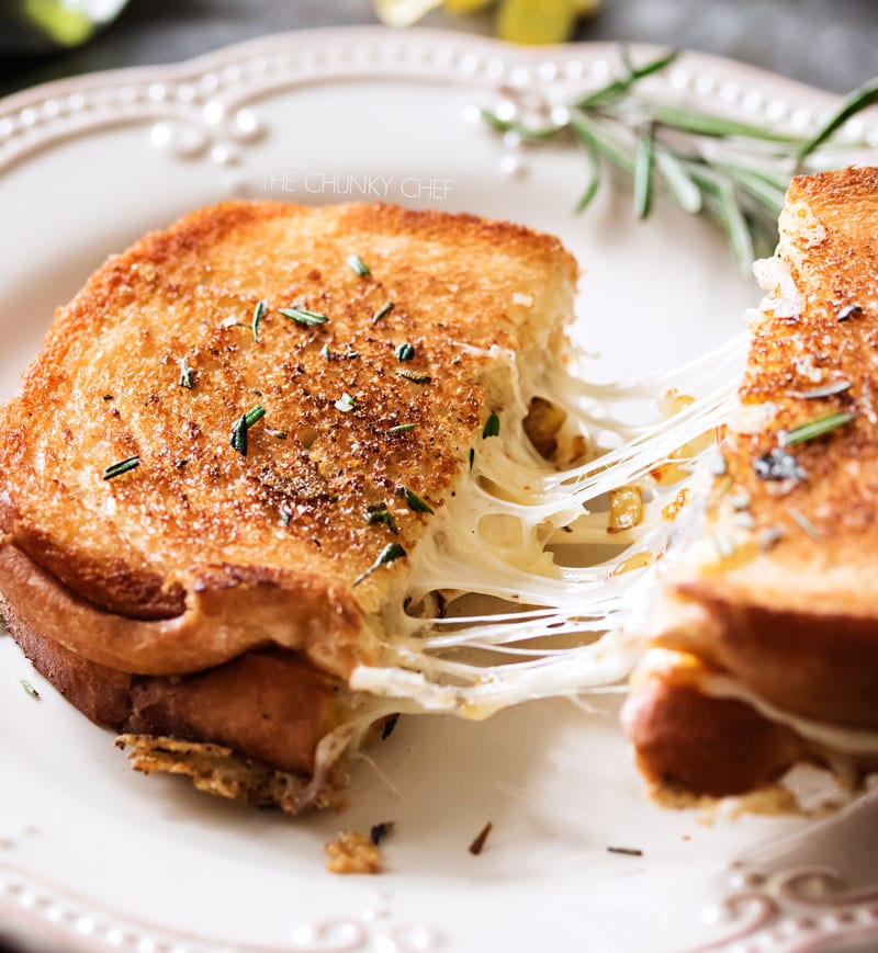 Ultimate Grilled Cheese | Gooey Gruyere and white cheddar cheese, savory rosemary butter, and herbed caramelized onions... need I say more? | http://thechunkychef.com