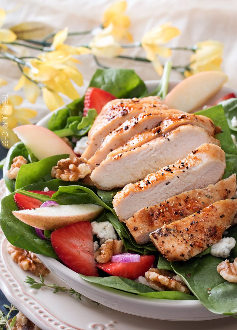 Grilled Chicken Strawberry Spinach Salad | This strawberry spinach salad is full of walnuts, fruits, cheeses, topped with juicy grilled chicken and a homemade honey herb vinaigrette! | http://thechunkychef.com