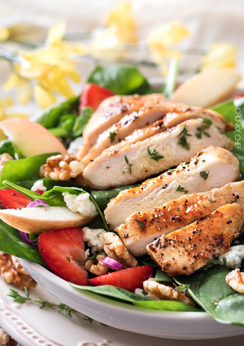 Grilled Chicken Strawberry Spinach Salad | This strawberry spinach salad is full of walnuts, fruits, cheeses, topped with juicy grilled chicken and a homemade honey herb vinaigrette! | http://thechunkychef.com