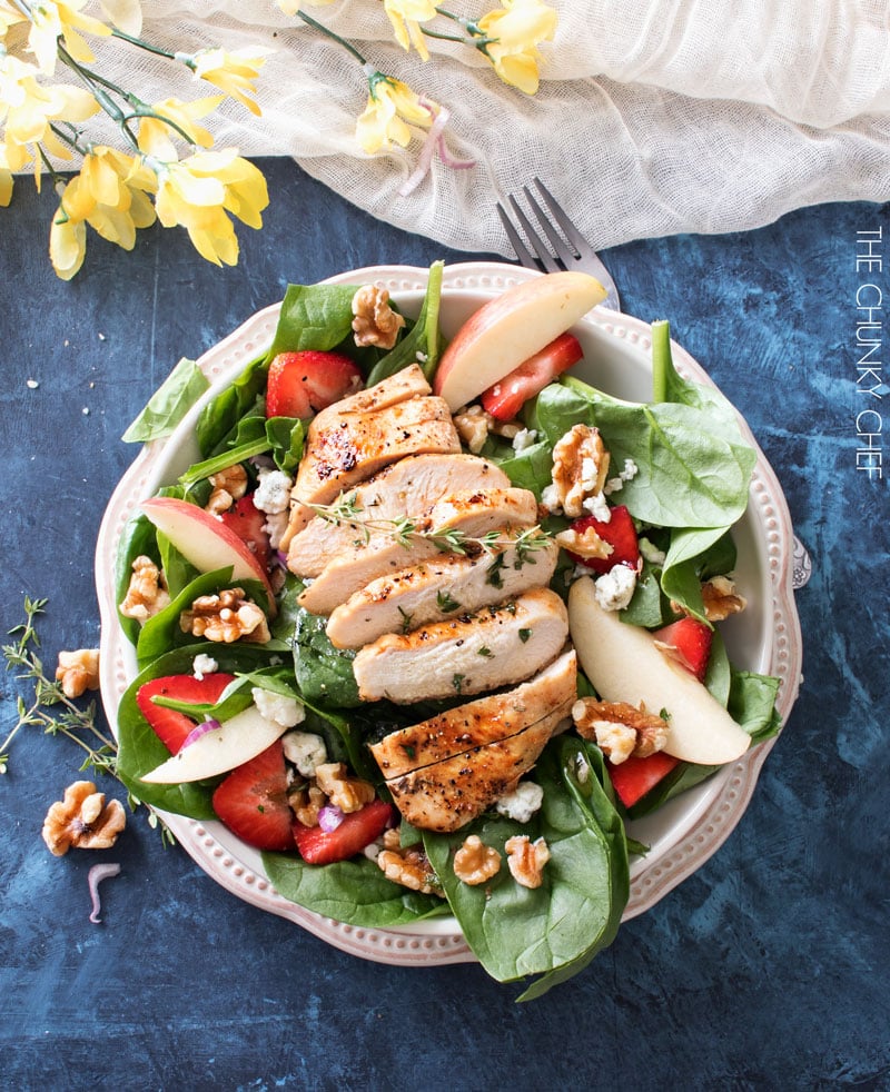 Grilled Chicken Strawberry Spinach Salad | This strawberry spinach salad is full of walnuts, fruits, cheeses, topped with juicy grilled chicken and a homemade honey herb vinaigrette! | http://thechunkychef.com