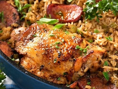 One Pot Chicken and Dirty Rice | Chicken thighs are cooked on top of a homemade dirty rice, which makes for the most flavorful Cajun-inspired dish you've ever had! Plus, all you need is one pot! | http://thechunkychef.com