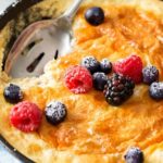 Mixed Berry Baked Oatmeal Souffle | Soft, fluffy oatmeal is folded with whipped egg whites and swirled with mixed berries, then baked until puffed and golden! | http://thechunkychef.com