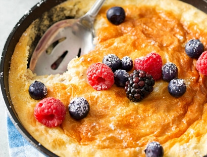 Mixed Berry Baked Oatmeal Souffle | Soft, fluffy oatmeal is folded with whipped egg whites and swirled with mixed berries, then baked until puffed and golden! | http://thechunkychef.com
