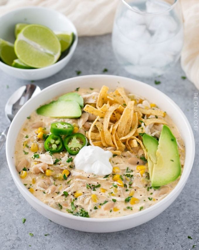 Bowl of white chicken chili with toppings