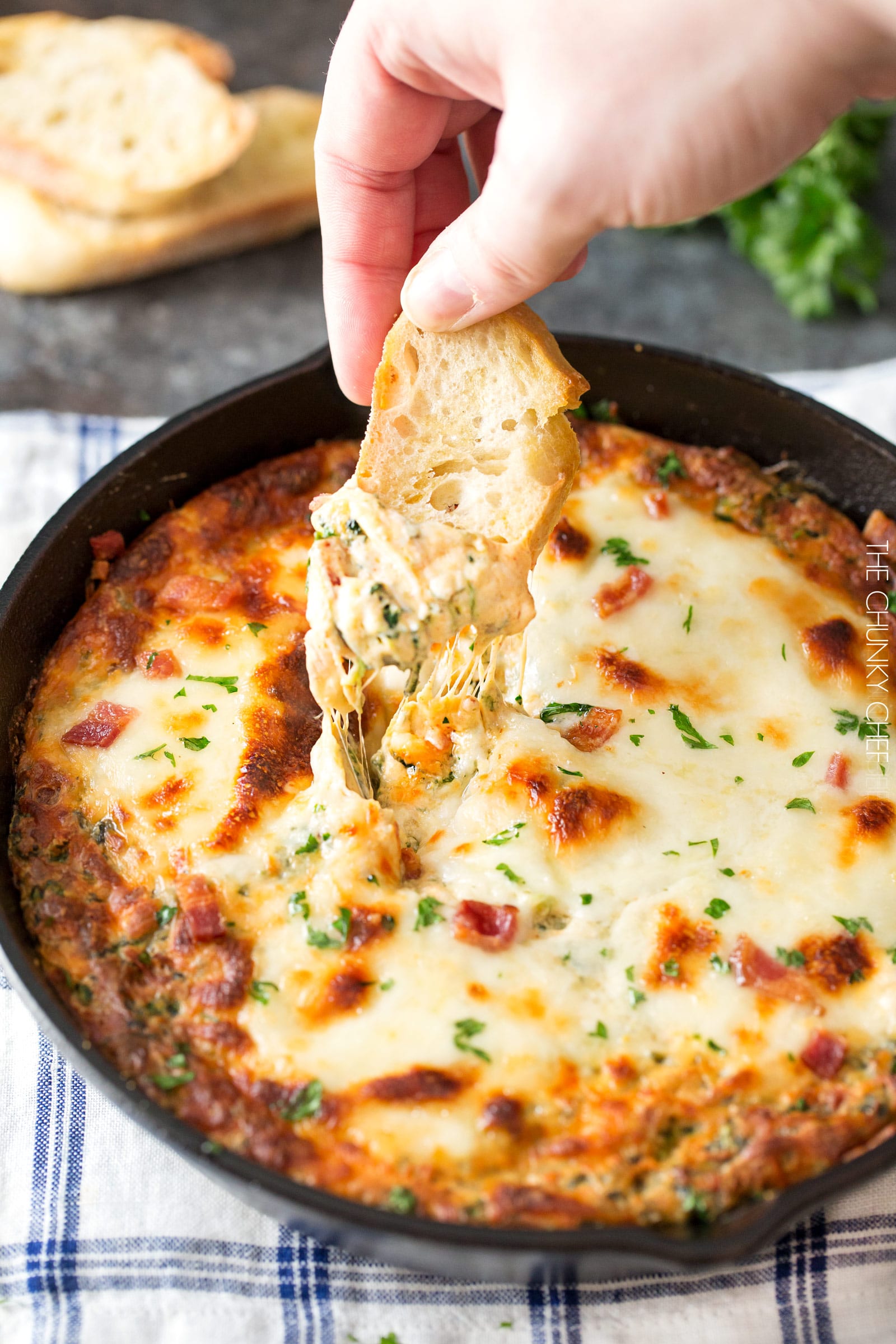 Cheesy Bacon Spinach Dip | This party spinach dip is loaded with tons of spinach, gooey cheese, crispy bacon and other mouthwatering flavors. Combine, bake, and eat! Perfect for a party! | http://thechunkychef.com